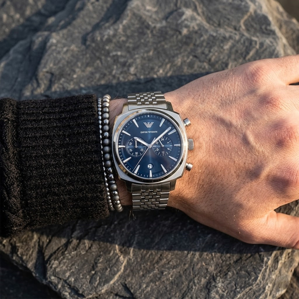 Close up of Emporio Armani Carlo AR11688 men's quartz battery watch on wrist showing deep blue dial and luxury silver eagle logo
