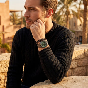Elegant man wearing Emporio Armani Carlo AR11689 men's quartz battery watch with gunmetal grey cushion case and luxury green dial