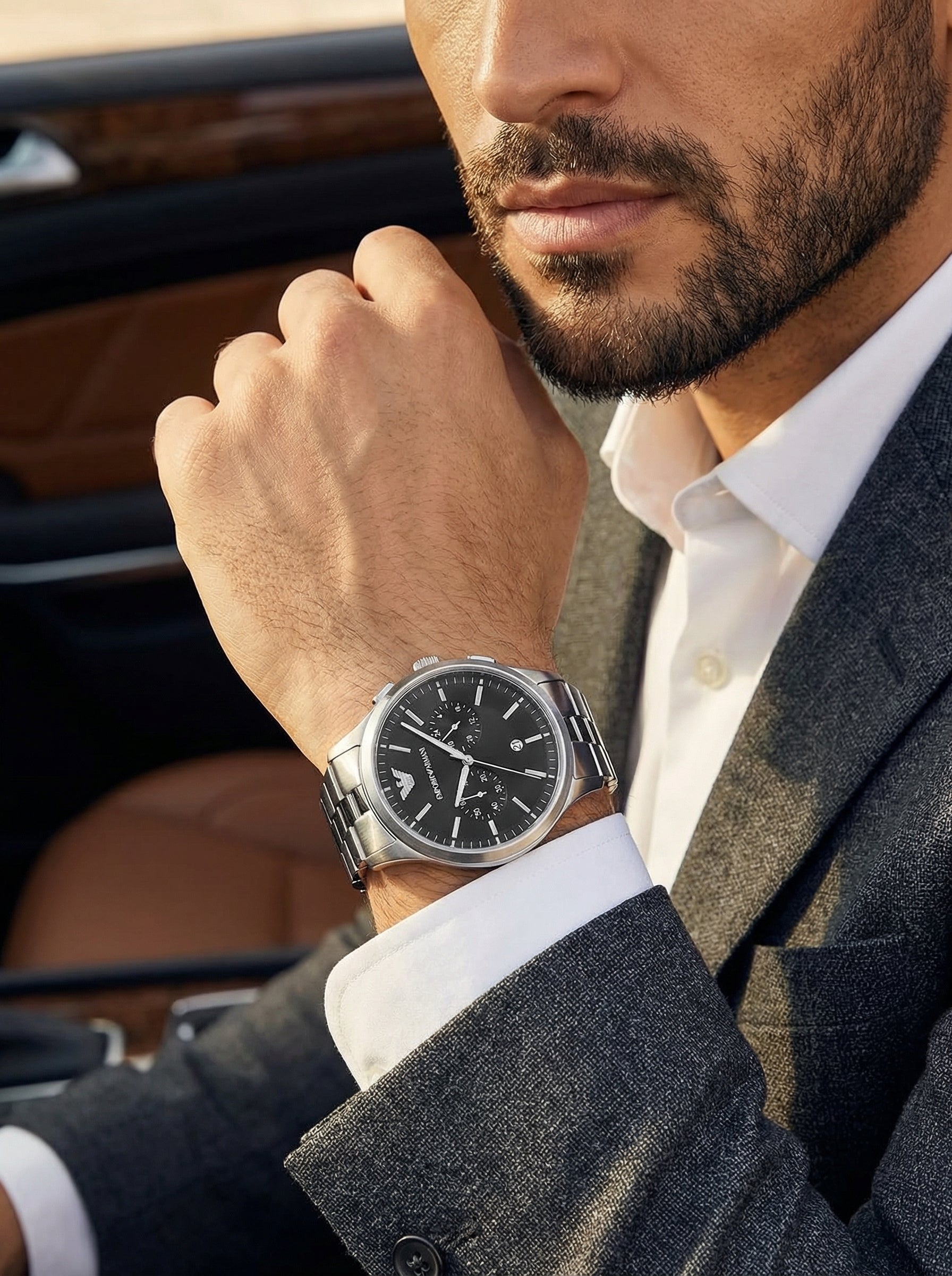 Lifestyle photo of Emporio Armani Dario AR11691 showing the bold silver watch on a man's wrist
