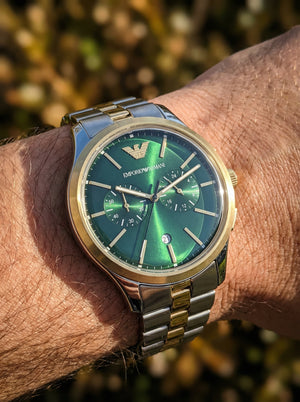 Close up shot of Emporio Armani Dario AR11692 on wrist showing green dial and chronograph sub-dials