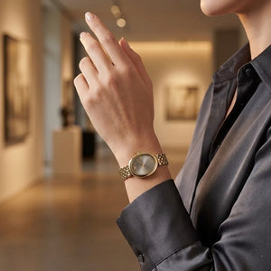 Lifestyle photo of Emporio Armani AR11707 showing the elegant gold watch on a woman's wrist