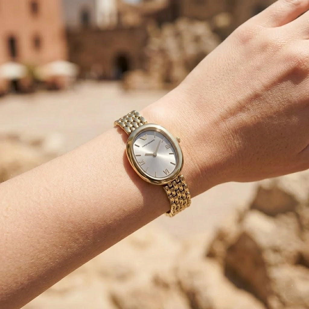 Lifestyle photo of Emporio Armani AR11707 showing the elegant gold watch on a woman's wrist