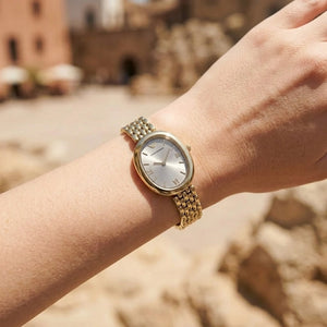 Lifestyle photo of Emporio Armani AR11707 showing the elegant gold watch on a woman's wrist