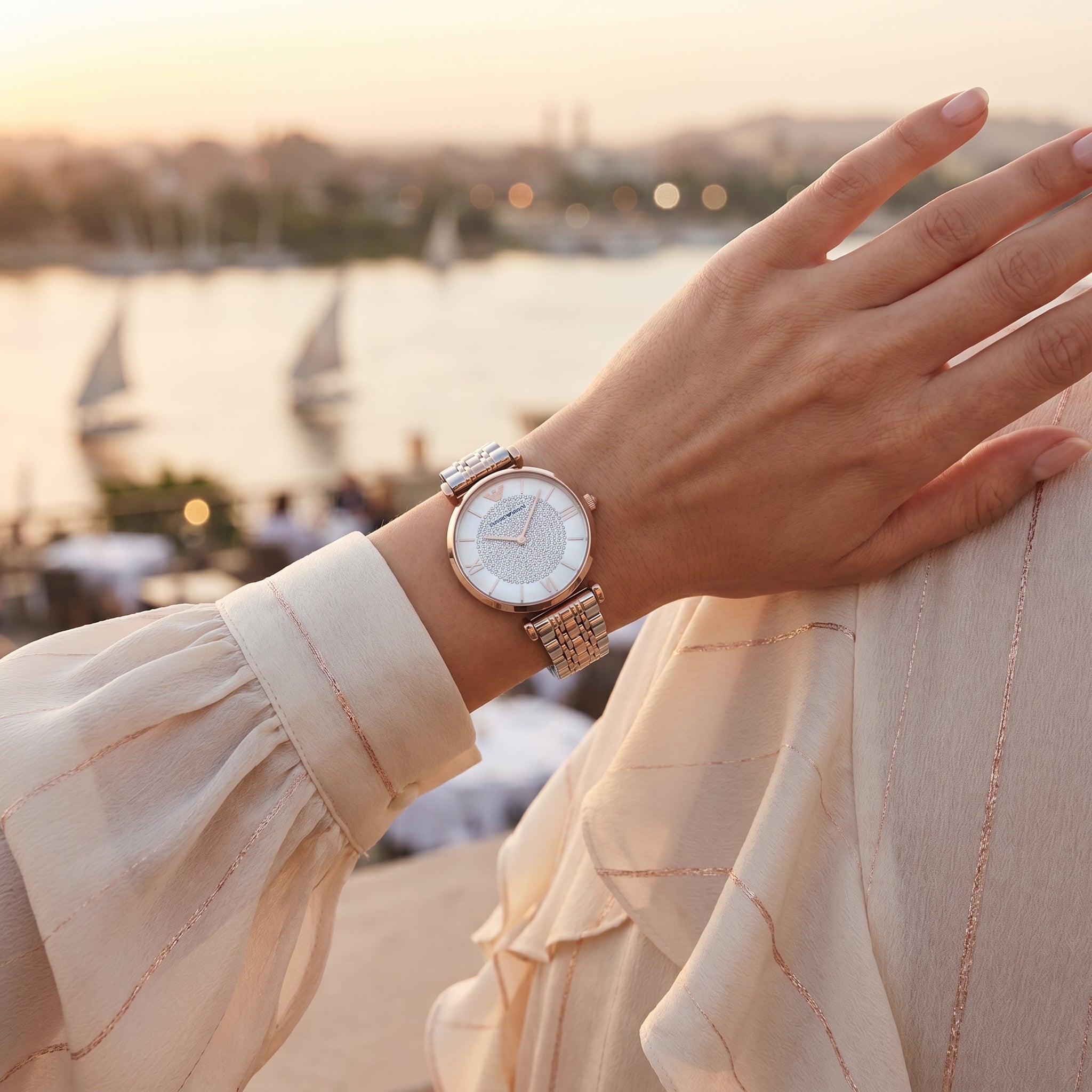 Female model wearing Emporio Armani Gianni T-Bar two-tone watch for a glamorous luxury look