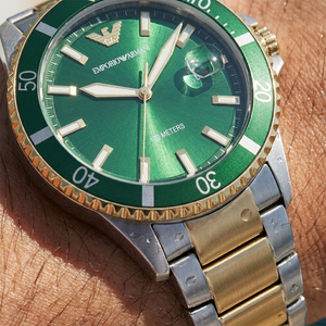 Close up of Armani AR80063 green dial showing date magnifier and luminous markers