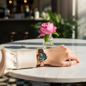 Elegant woman wearing Emporio Armani AR11197 rose gold mesh watch with silk blouse