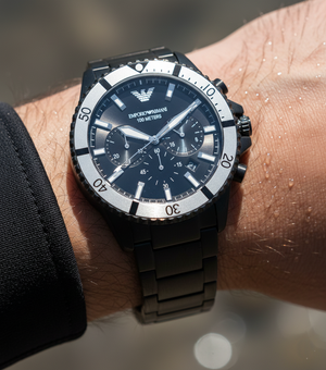 Extreme wrist macro of Armani AR80050 showing contrasting silver bezel and black dial