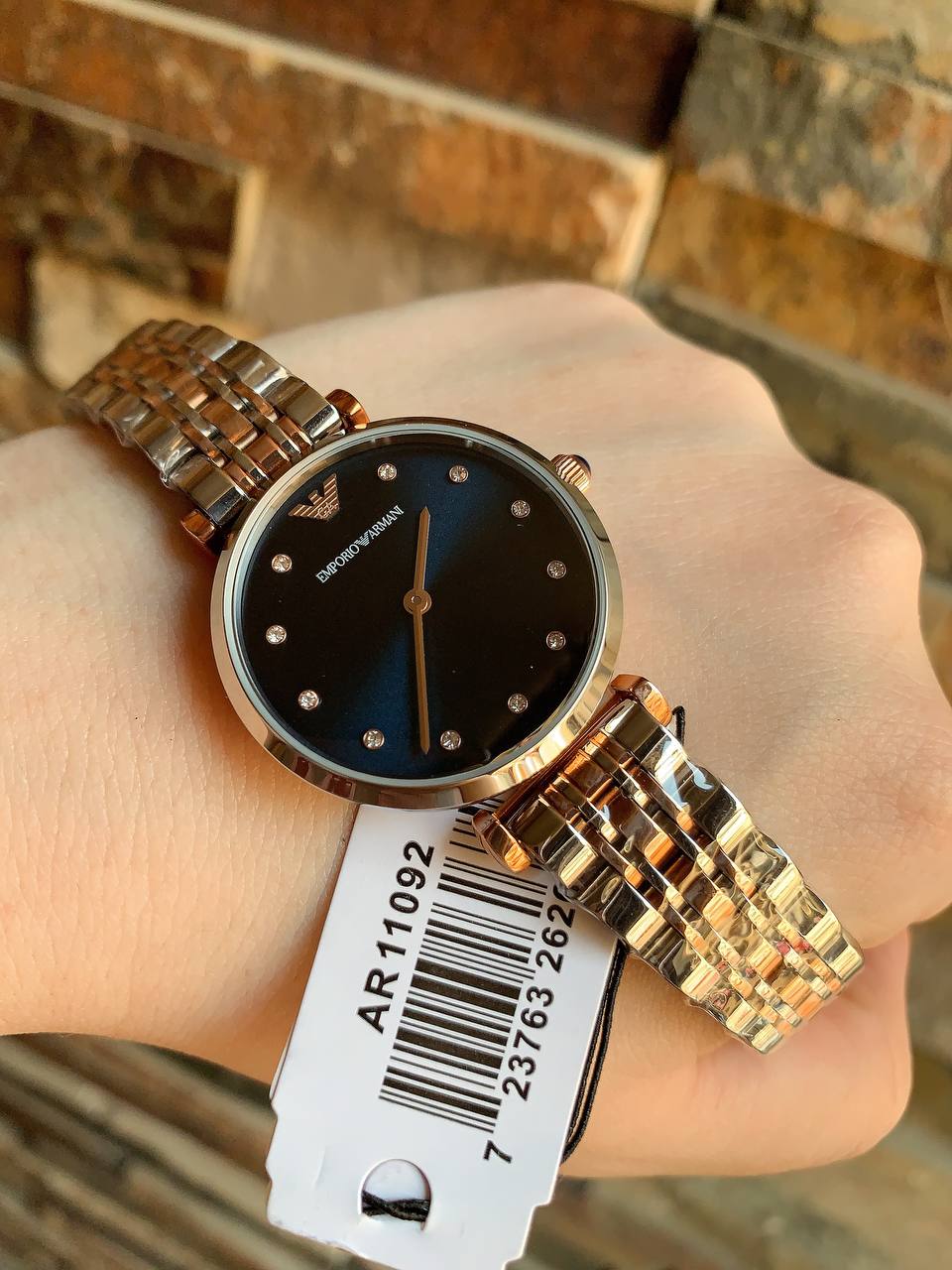 Detailed view of the mixed silver and rose gold stainless steel link bracelet for AR11092