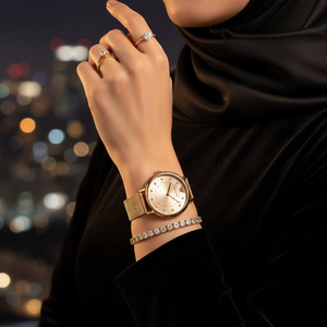 Elegant woman wearing Emporio Armani AR11129 gold mesh watch in professional setting
