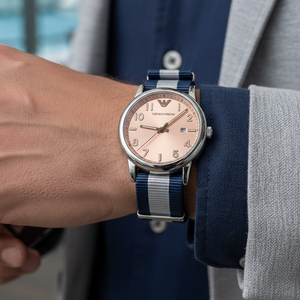Detailed wrist macro of Armani AR11212 peach dial and striped nylon strap texture