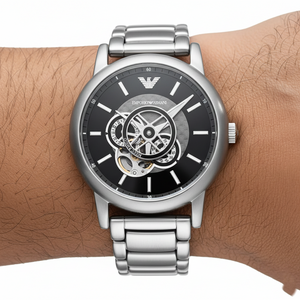 Close up of the AR60021 black dial showing the open-heart window revealing the mechanical movement