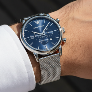 Extreme wrist macro of Armani AR80038 showing silver mesh strap weave and blue dial