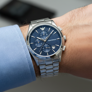 Extreme wrist macro of Armani AR11528 showing intricate geometric pattern on blue dial