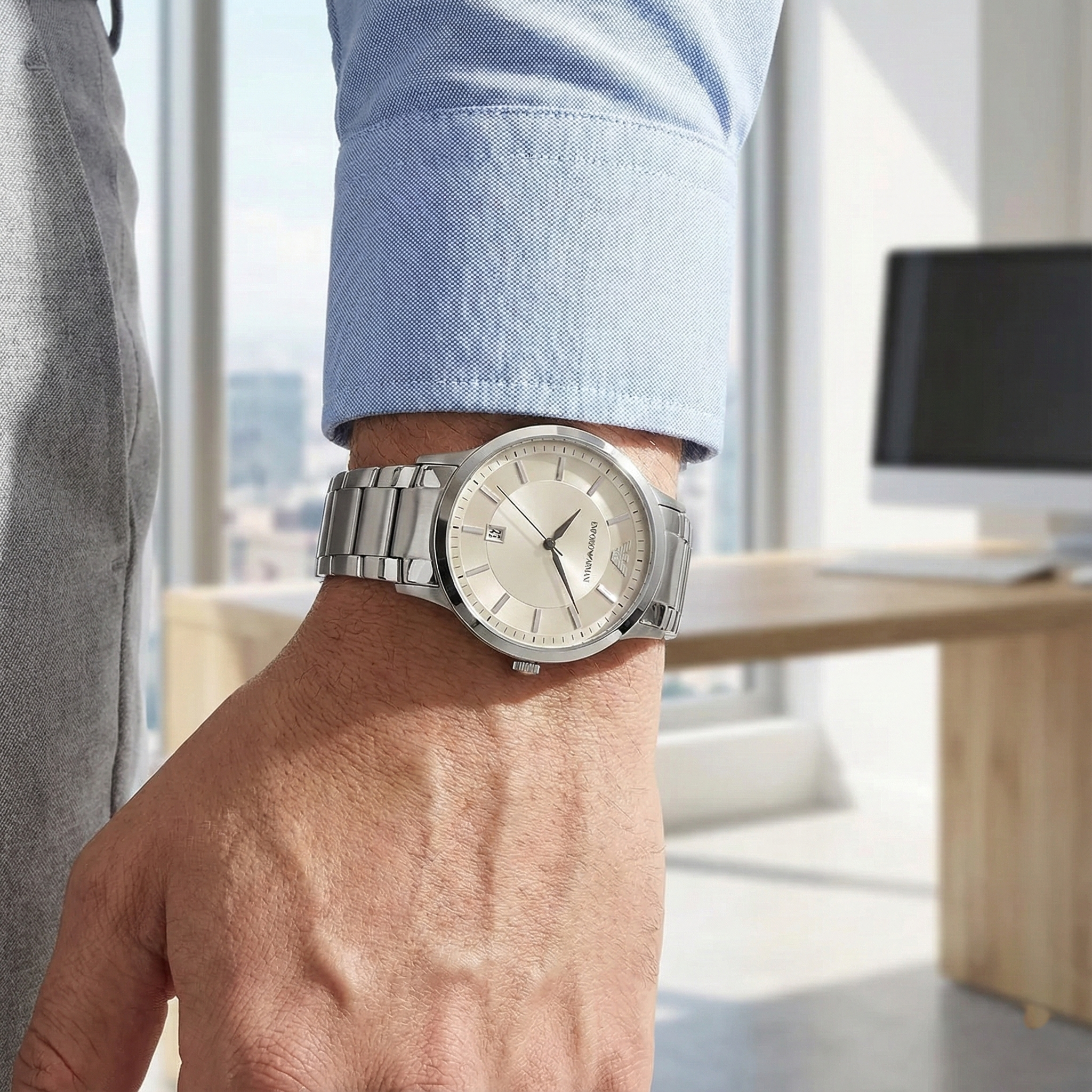 Professional man wearing Emporio Armani AR2431 silver watch in a modern office setting
