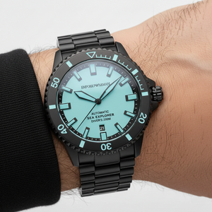 Close up of the black unidirectional rotating timing bezel with turquoise markers on the AR60084