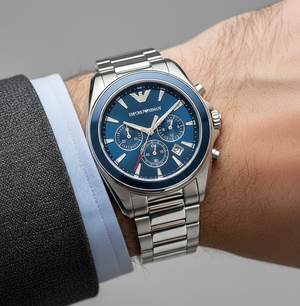 Extreme wrist macro of Armani AR6091 blue dial and silver indices with suit cuff