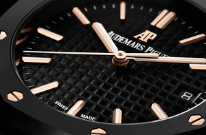 Audemars Piguet Royal Oak men's automatic watch, black dial, black bracelet – angle close-up on dark background