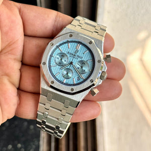 Audemars Piguet Royal Oak men's chronograph watch, light blue dial, silver stainless steel bracelet – in-hand angle view