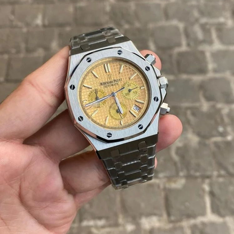 Audemars Piguet Royal Oak men's chronograph watch, yellow dial, silver stainless steel bracelet – in-hand view