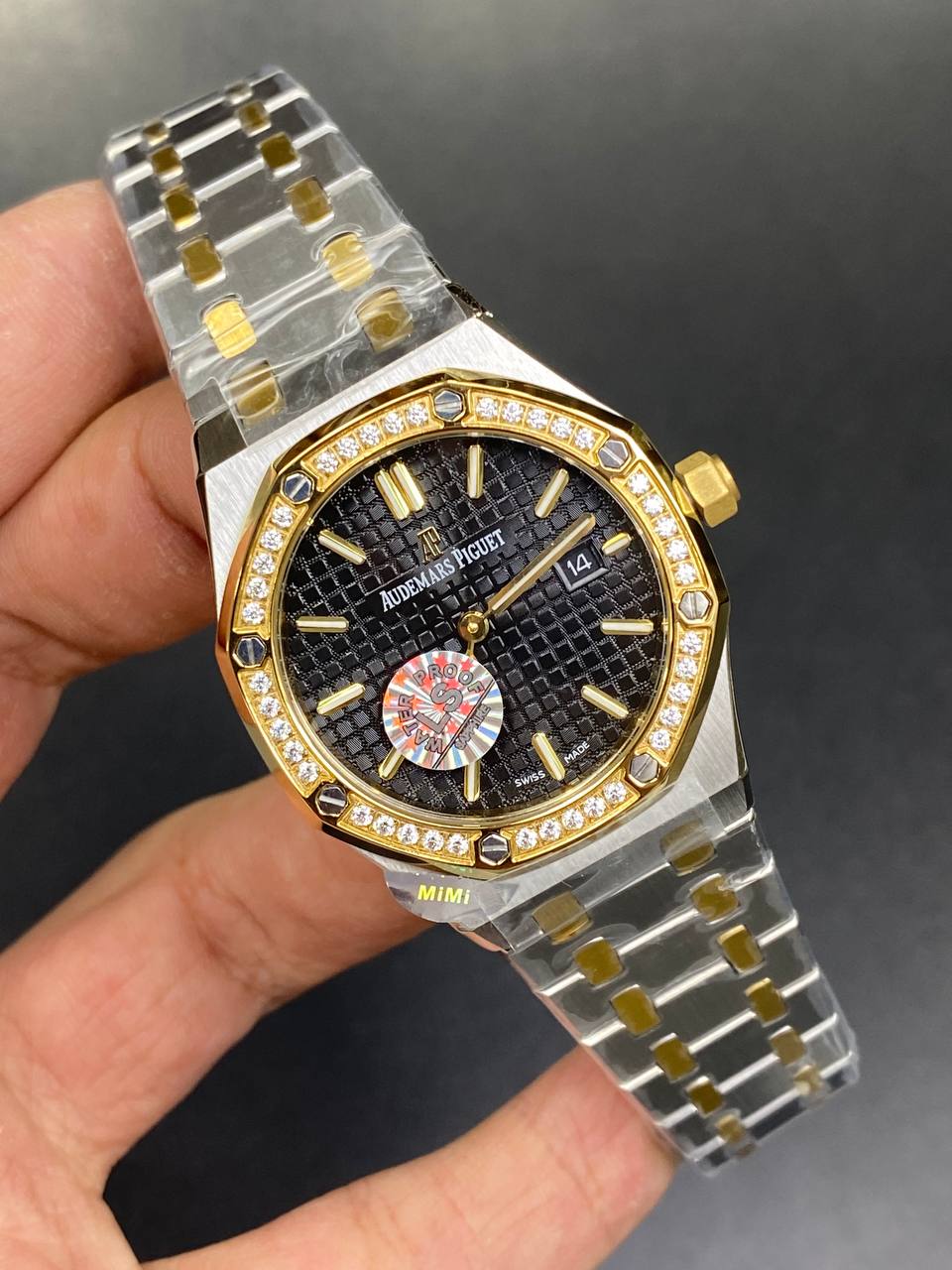 Audemars Piguet Royal Oak women's quartz watch, 33mm case, black dial, diamond bezel, two-tone yellow gold and stainless steel bracelet – in-hand view