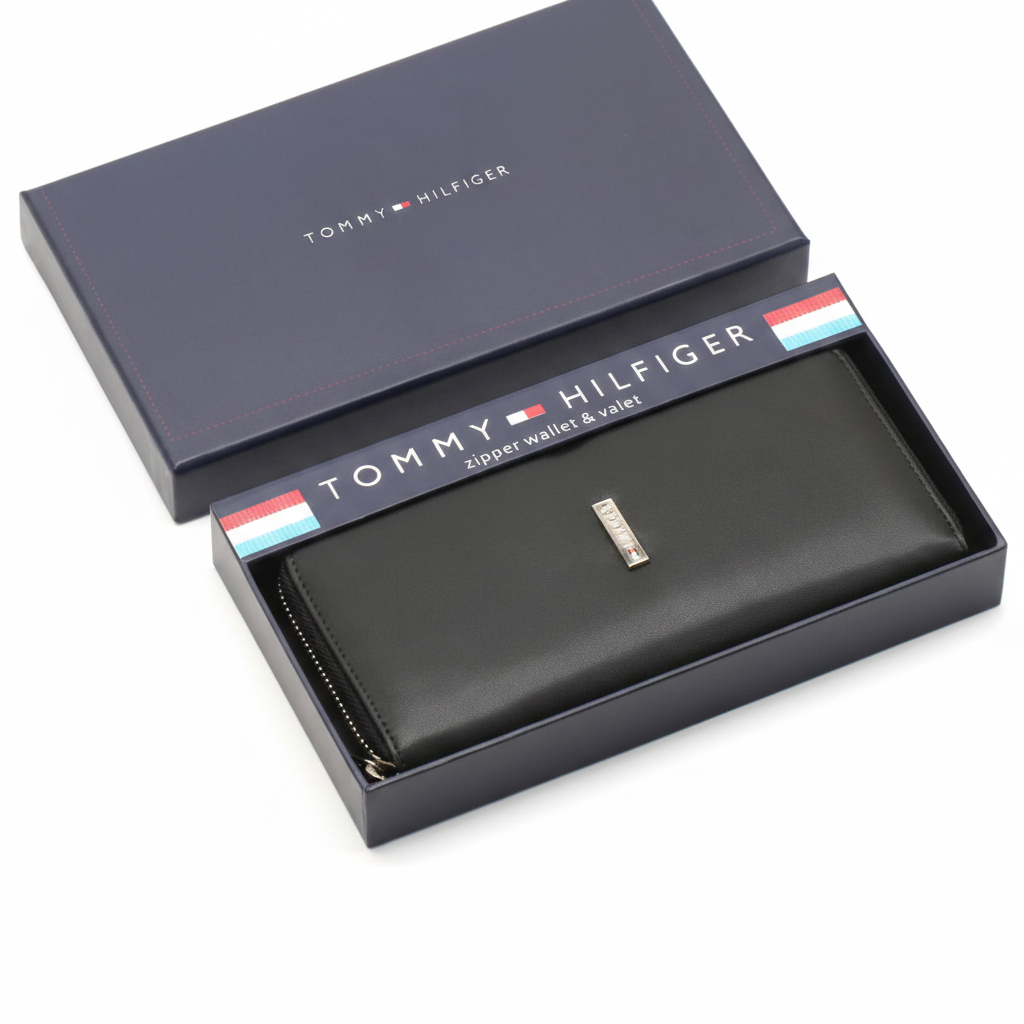 A black leather bifold wallet resting inside its open presentation gift box, with the box cover displayed alongside.