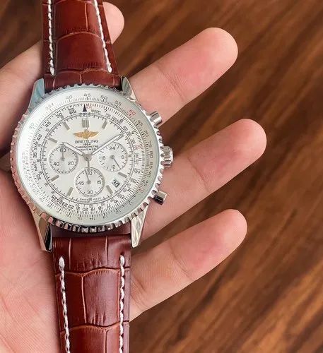 Breitling Navitimer 46mm men's chronograph watch, 46mm stainless steel case, white dial, brown leather strap – hand-held close-up