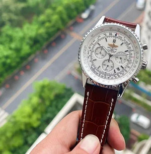 Breitling Navitimer 46mm men's chronograph watch, 46mm stainless steel case, white dial, brown leather strap – hand-held outdoor view