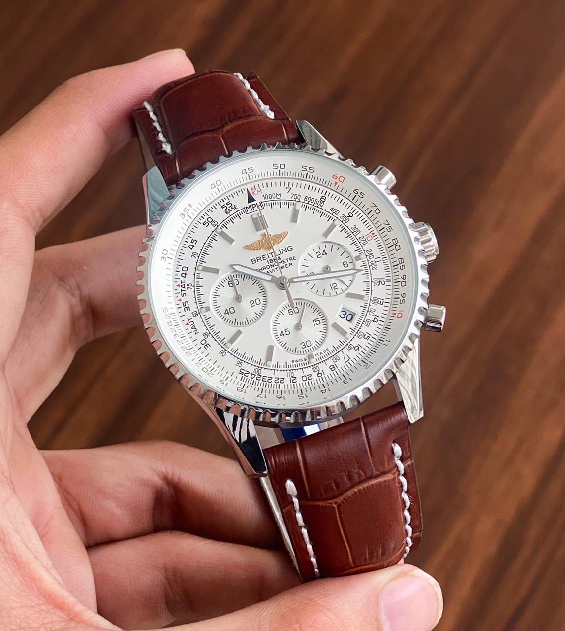 Breitling Navitimer 46mm men's chronograph watch, 46mm stainless steel case, white dial, brown leather strap – hand-held view