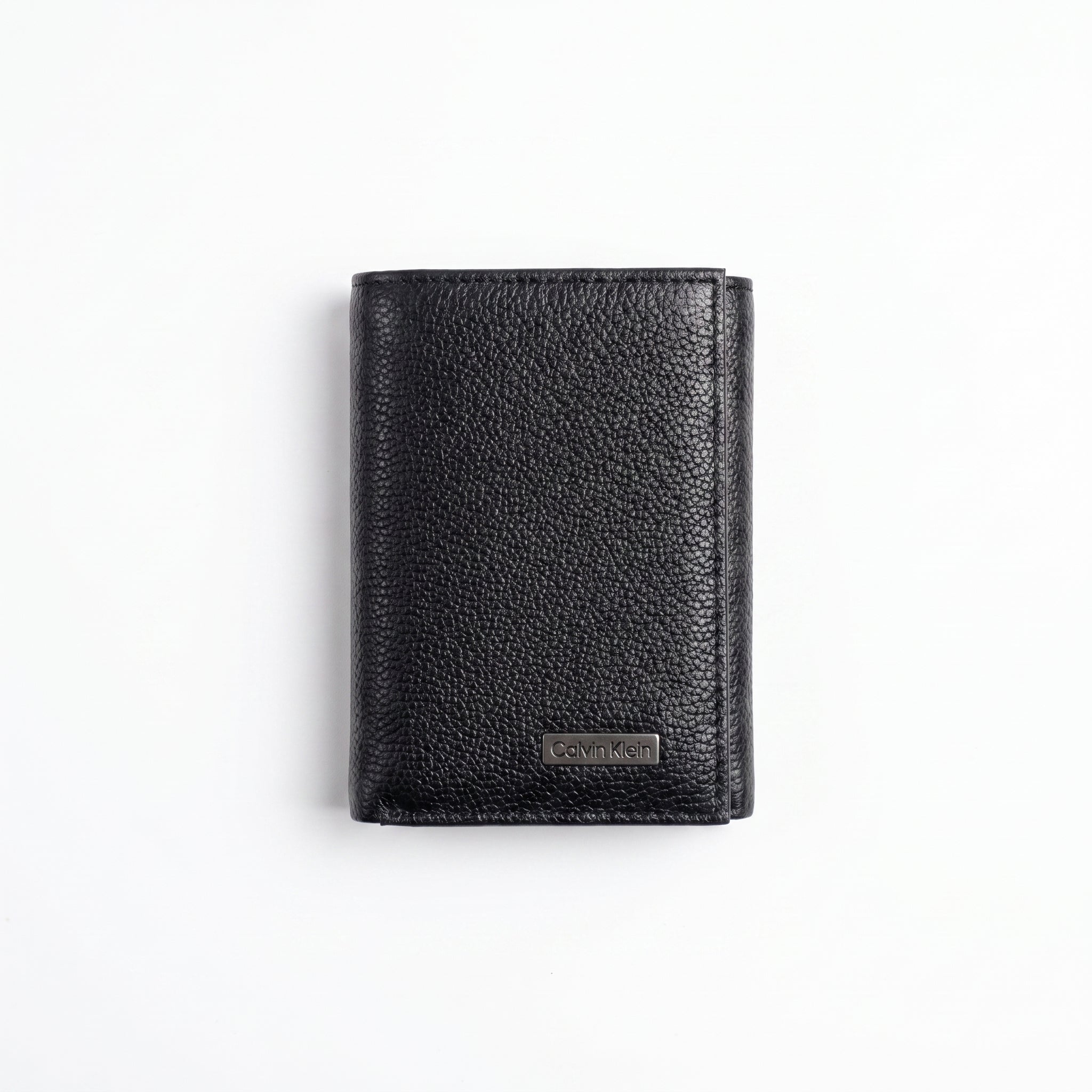 Professional angled studio view of the sleek Calvin Klein mirror original bi-fold leather wallet