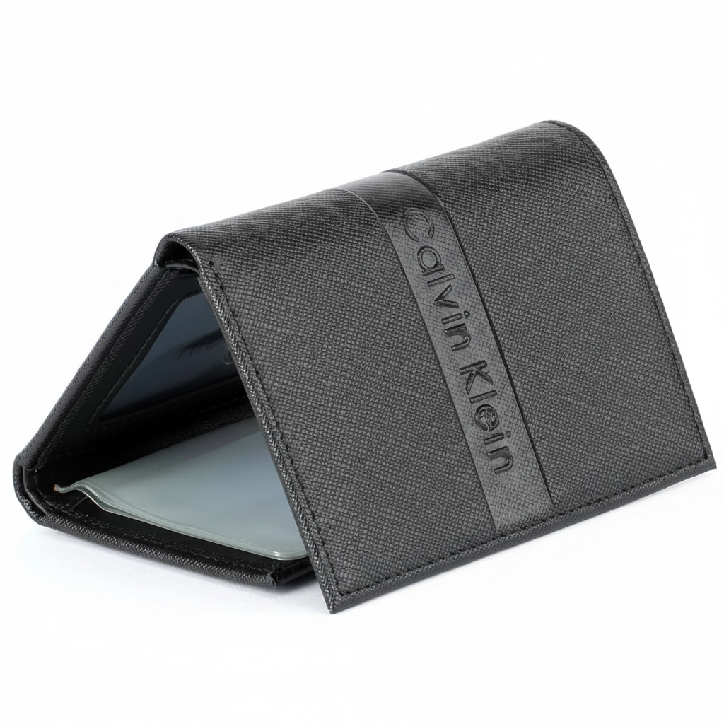 Perspective view of a standing semi-open Calvin Klein men's black saffiano leather flap wallet, displaying the front debossed logo and a glimpse of the clear ID window inside