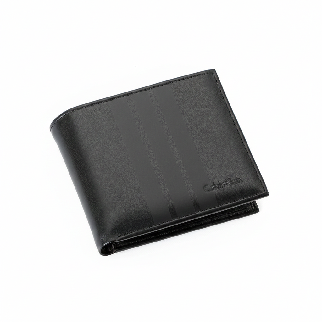 High-angle view of a closed Calvin Klein men's black leather bifold wallet resting on a white surface, highlighting the distinctive matte vertical center stripe and debossed logo