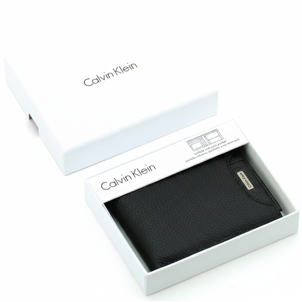 Top-down view of a Calvin Klein men's black pebbled leather wallet displayed securely inside its original white branded gift box