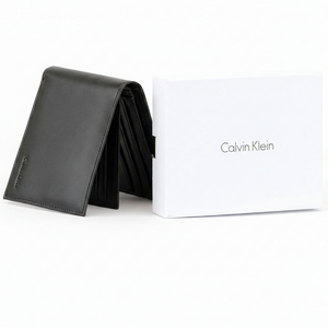 Perspective view of a standing semi-open Calvin Klein men's black leather wallet displaying the front logo and showcasing an extra interior flap with multiple card slots