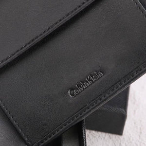 Close-up of a black Calvin Klein handbag with visible branding.