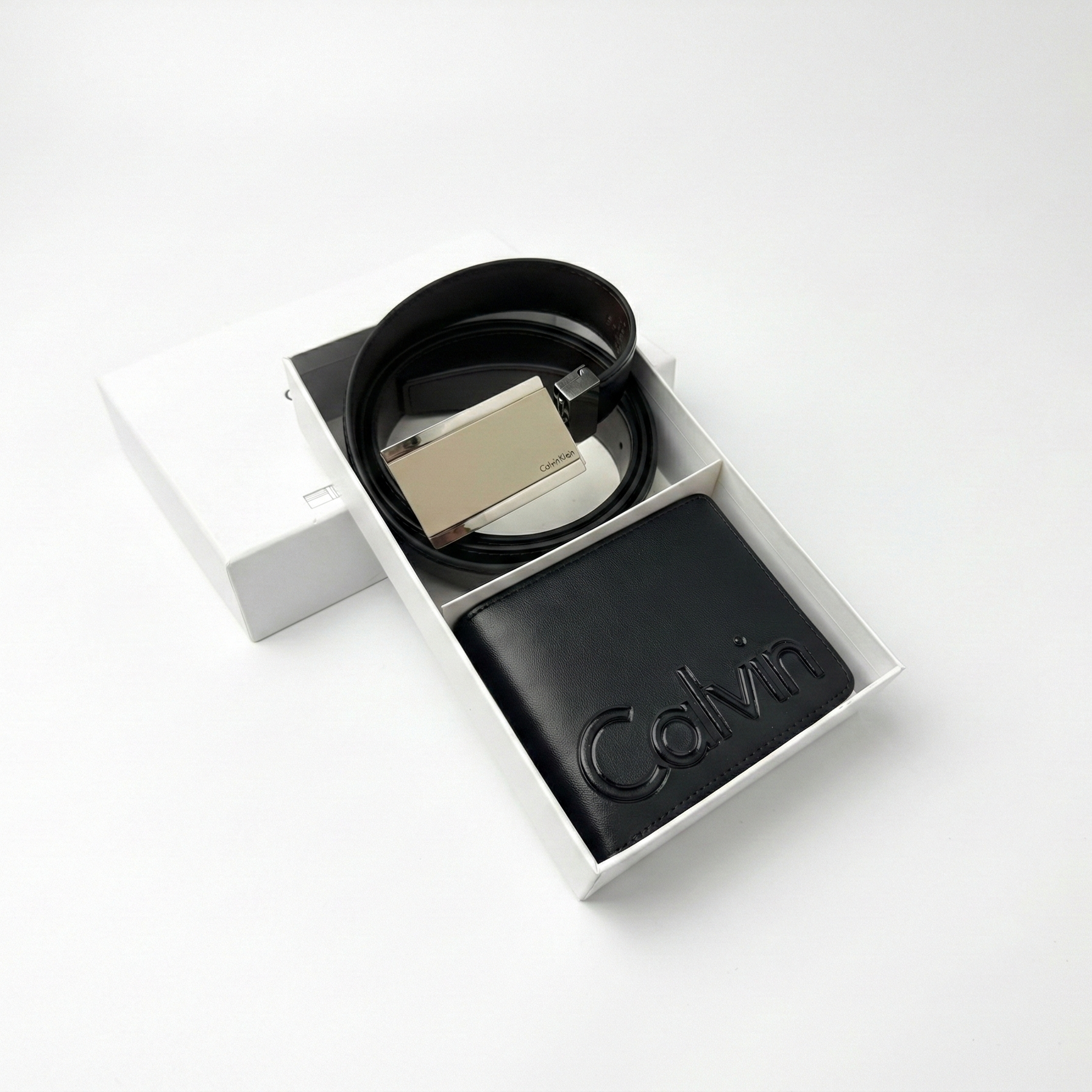 Flat lay of Calvin Klein gift set featuring reversible black brown belt and wallet