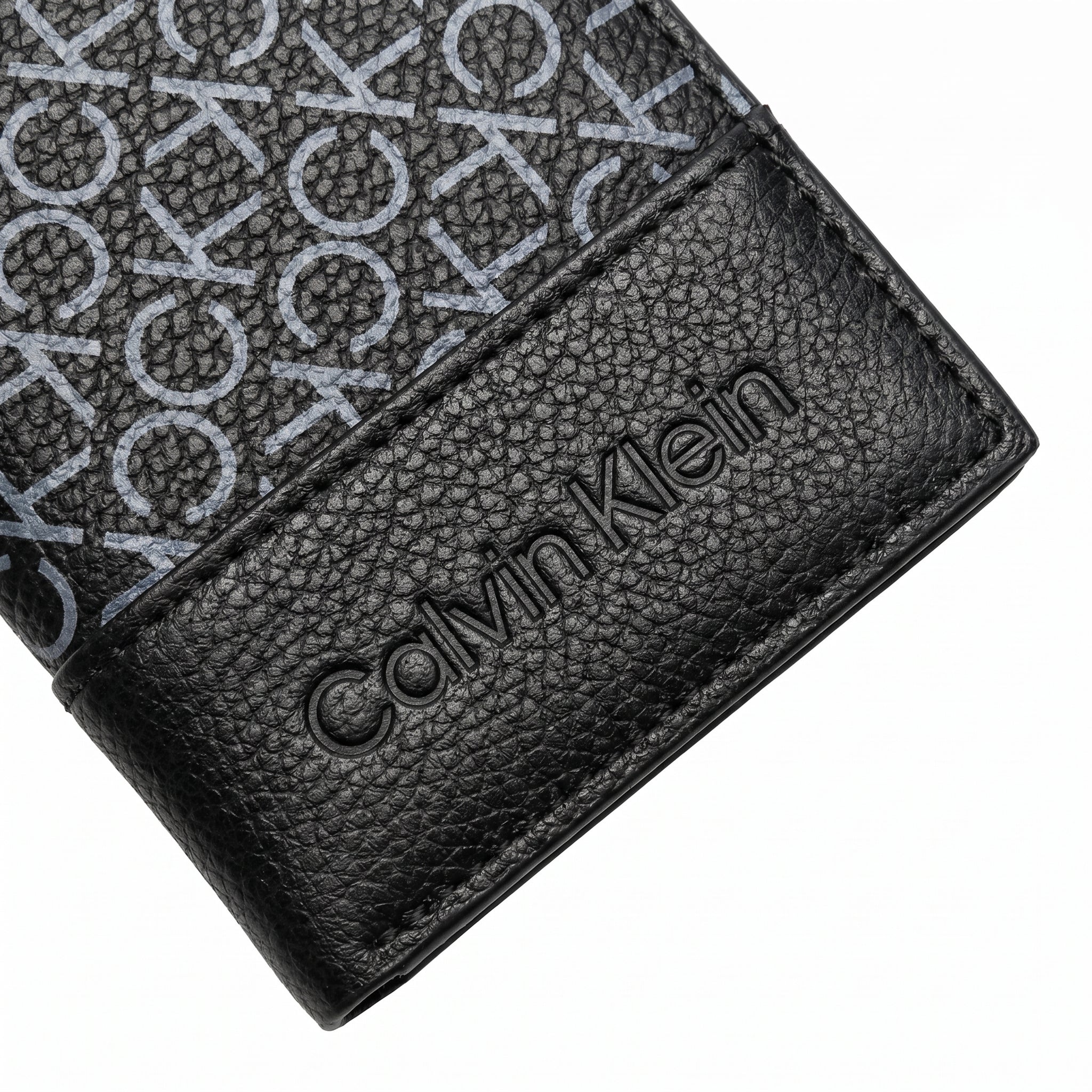 Professional angled studio photograph of the sleek Calvin Klein mirror original grey printed monogram bi-fold leather wallet
