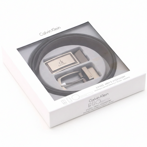 Luxury Calvin Klein men's 3-piece accessory gift set showcasing a black leather belt and two interchangeable buckles inside a premium branded window box