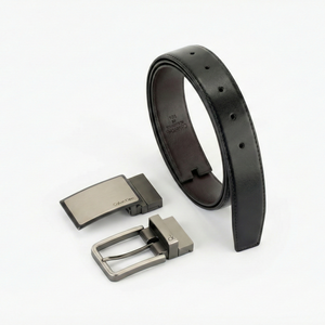 Perspective view of the Calvin Klein men's leather belt gift set showing the premium black side with two interchangeable gunmetal buckles