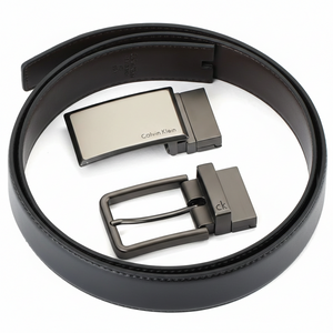 Detailed view of two premium metal buckles from the Calvin Klein men's belt gift set: a sleek modern plaque buckle and a classic pin buckle