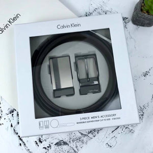 Premium Calvin Klein men's gift set featuring a reversible black and brown leather belt with two interchangeable metal buckles, presented in a luxury white branded box and shopping bag