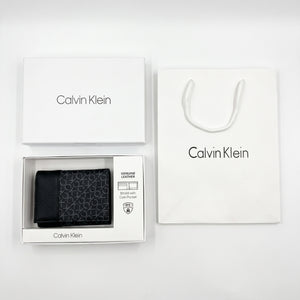 Full presentation of the Calvin Klein mirror original grey printed monogram leather wallet set with original white gift box and shopping bag