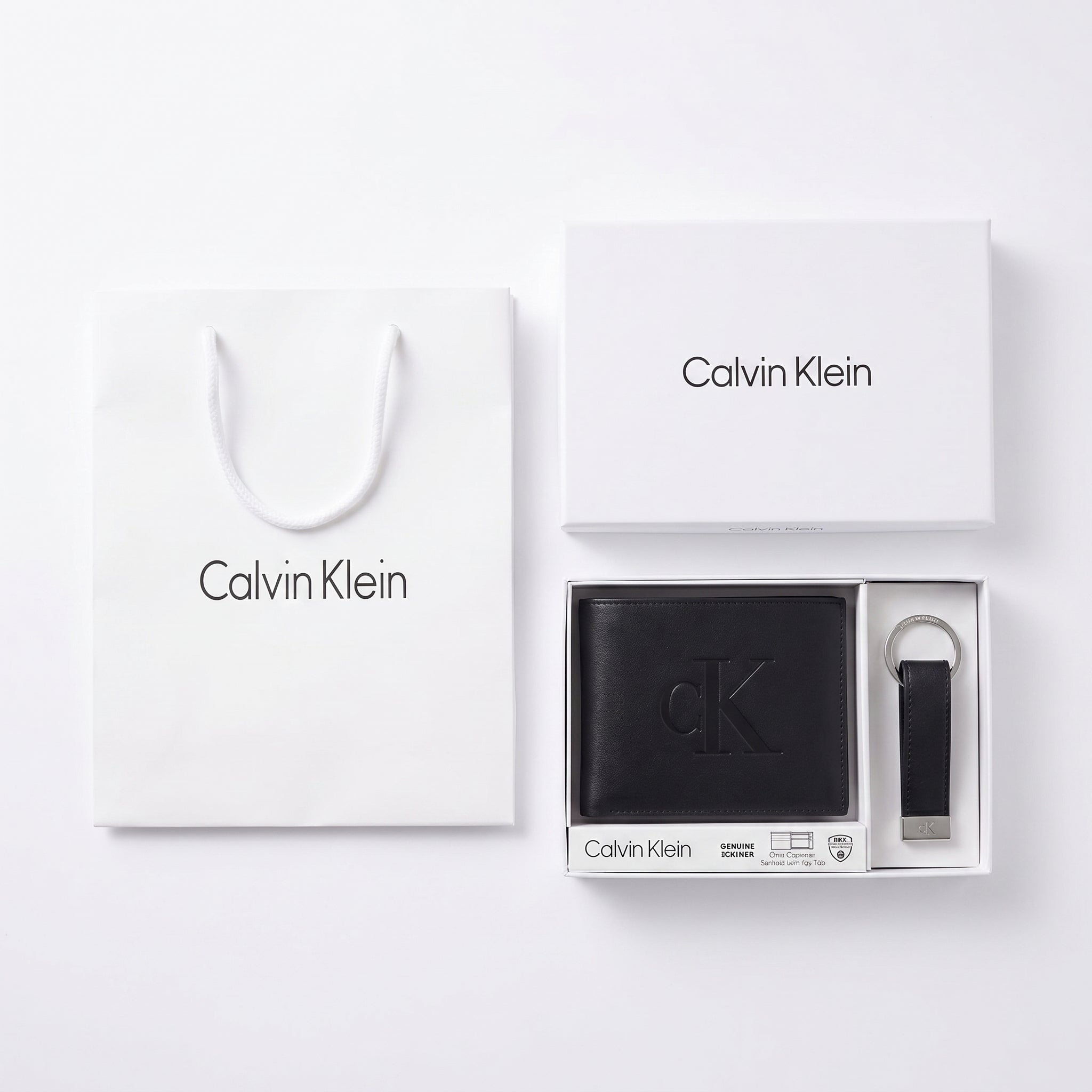 Full presentation of the Calvin Klein mirror original leather wallet and key fob gift set with signature white box and shopping bag