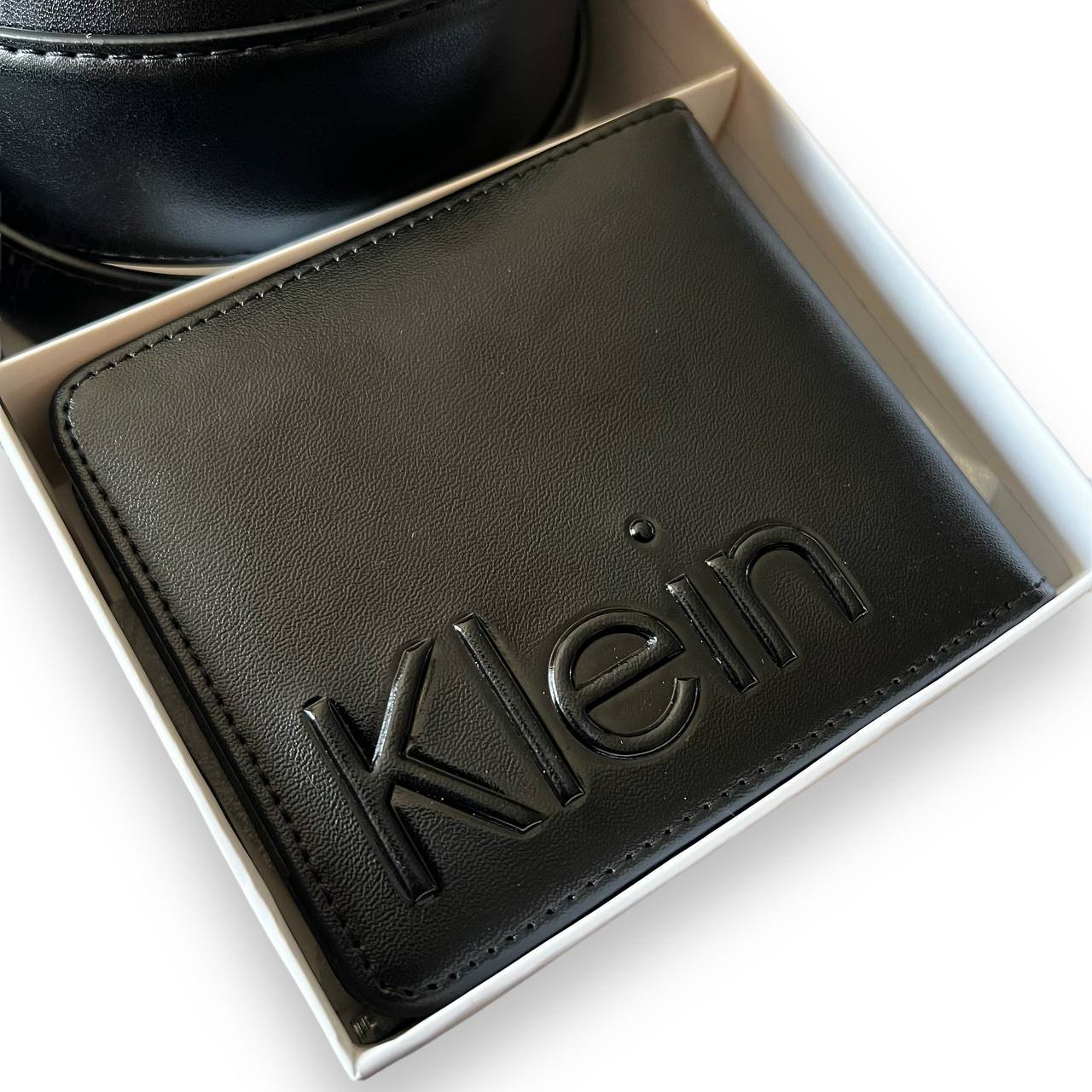 Front view of the Calvin Klein men's black leather belt and matching bifold wallet gift set.
