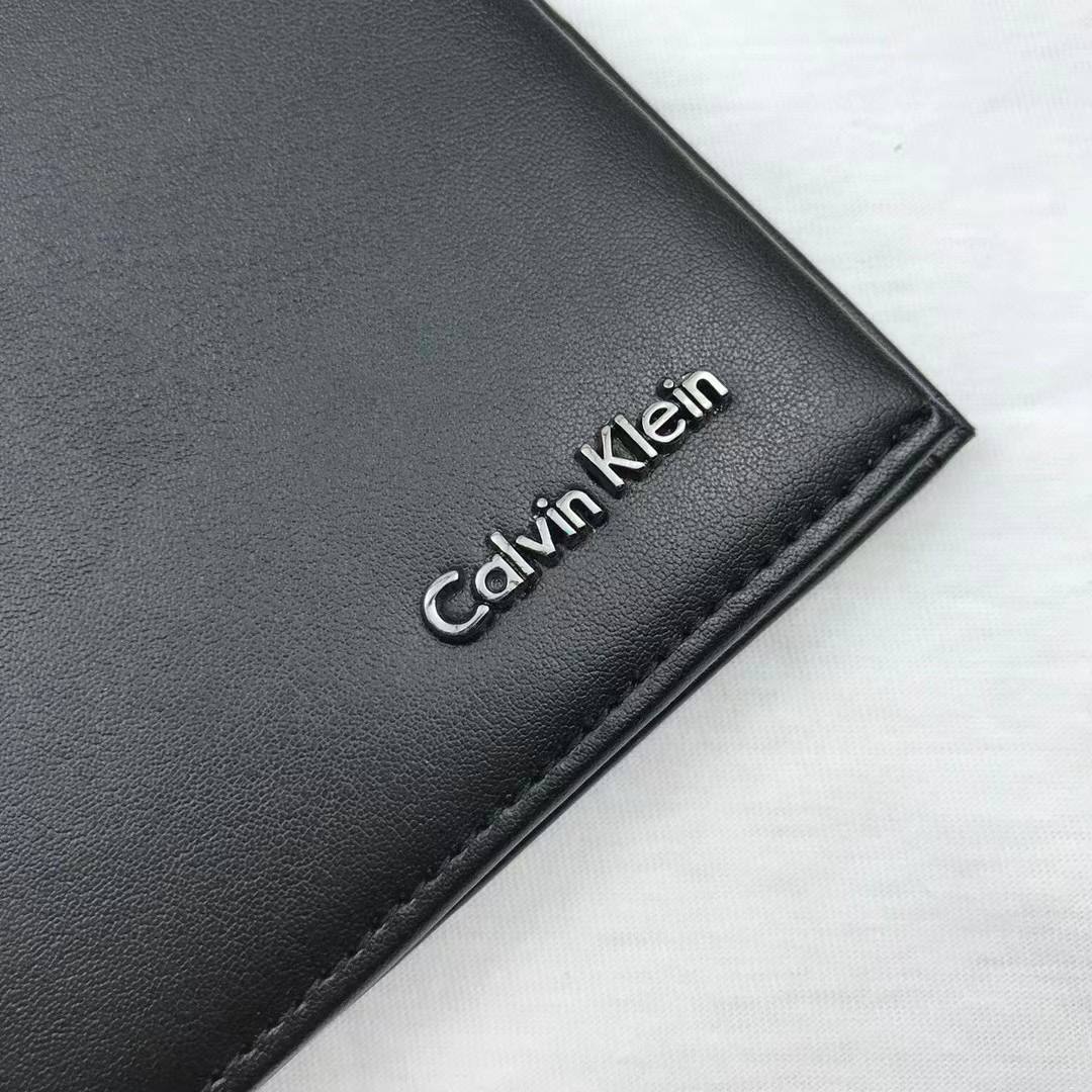 Close up of Metal Calvin Klein Logo on Black Leather Wallet