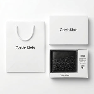 Full luxury presentation of the Calvin Klein mirror original smooth black leather bifold wallet with its premium white branded gift box and matching shopping bag