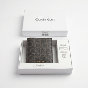 Top-down studio product photography of the Calvin Klein mirror original smooth black leather wallet neatly resting inside its open custom white branded gift box