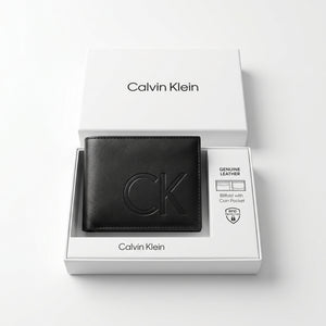 Top-down studio product photography of the Calvin Klein mirror original smooth black leather wallet neatly resting inside its open custom white branded gift box
