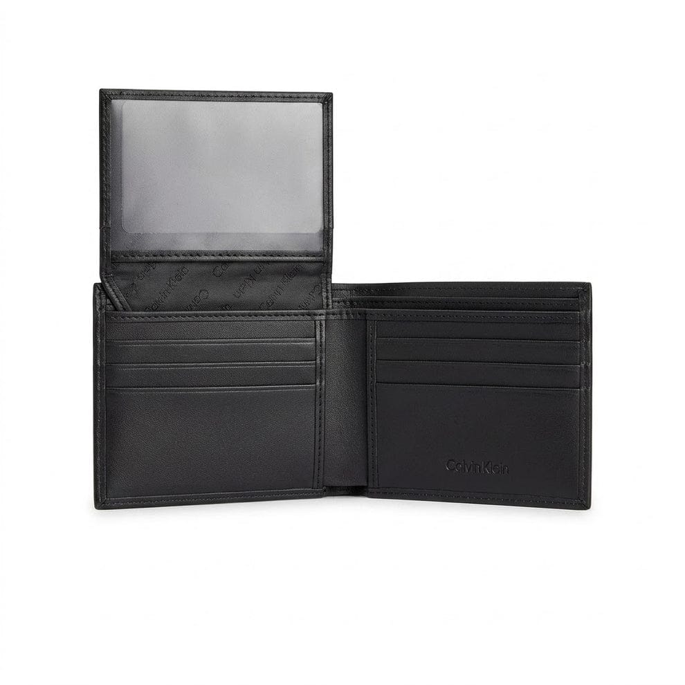 Live interior view of the opened Calvin Klein smooth black leather bifold wallet showcasing symmetrical multi-card slots and premium stitched edges
