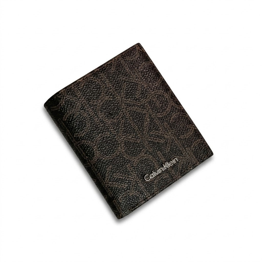 Macro close-up studio shot focusing on the round silver metal CK hardware logo and vertical stitching details over black smooth genuine leather