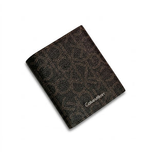 Macro close-up studio shot focusing on the round silver metal CK hardware logo and vertical stitching details over black smooth genuine leather